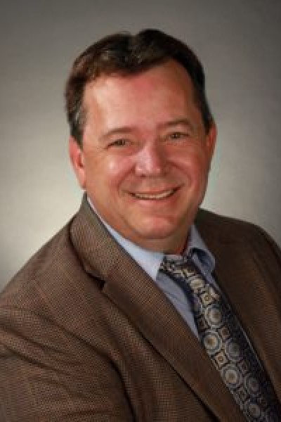 Smiling middle-aged man wearing suit and tie