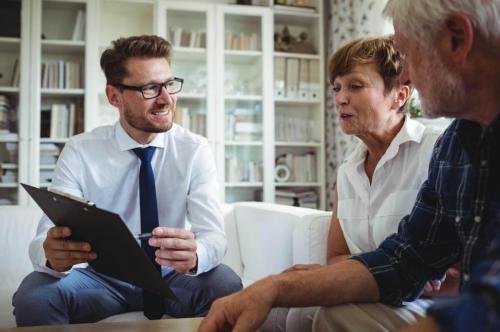 Financial advisor consulting senior couple at home